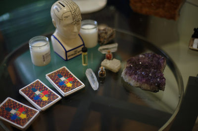 Tarot Card Reading table with Tarot Cards, crystals, candles and blessed oils.