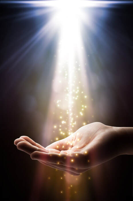 Spiritual Light is casting gold glitter on an hand. Angel Channeling Visual for Elaine Psychic - Angel Medium